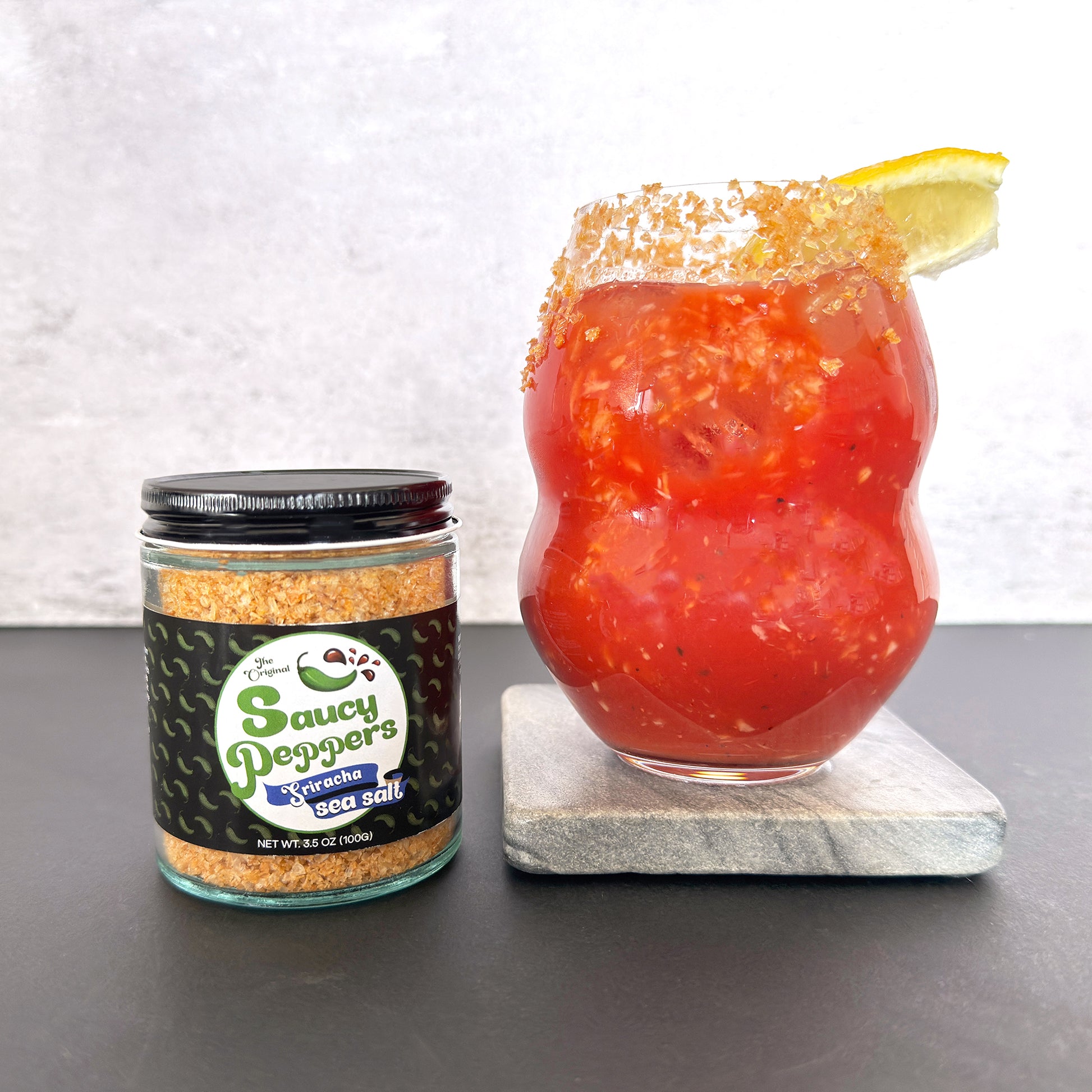 Sriracha infused sea salt by Saucy Peppers finishes the rim of a Bloody Mary Cocktail