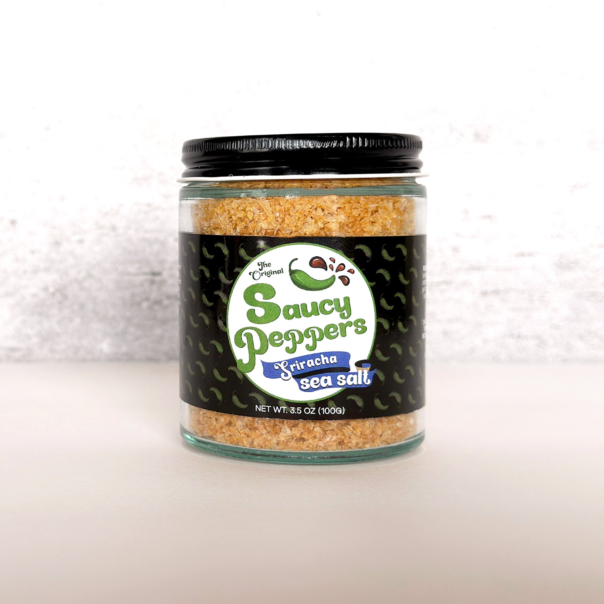 Sriracha Infused Sea Salt by Saucy Peppers artisanal condiment company with habanero chili pepper and sriracha flavors.